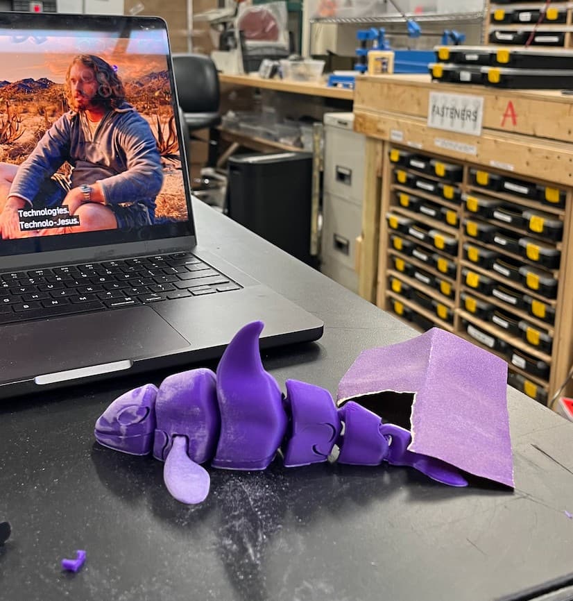 Sanding the purple orca at the makerspace